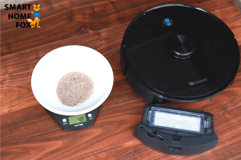 Weighing out the sand after the suction review of the Proscenic M7 Pro on laminate